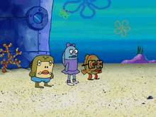 a group of spongebob characters are standing on a beach .