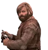 a man with long hair and a beard is holding a pair of scissors made with unse