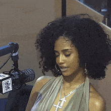 a woman is sitting in front of a microphone with a box that says fox