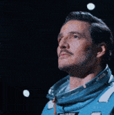 a woman in a space suit has a patch on her chest that says e storm
