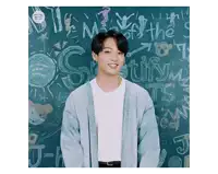 a young man is standing in front of a chalkboard that says spotify