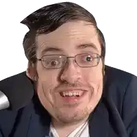 a man wearing glasses and a suit is making a funny face in front of a microphone