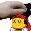 a cartoon character with a red bandana on his head is being touched by a hand .