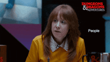a woman sitting in front of a sign that says dungeons & dragons adventure people