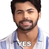 a man with a beard is smiling and the word yes is on his face