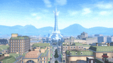 an aerial view of a city with a large tower in the distance