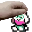 a hand is holding a pixel art of a panda .