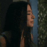 a woman is looking at herself in a mirror .