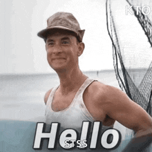 a man wearing a hat and a tank top is standing on a boat and saying hello .