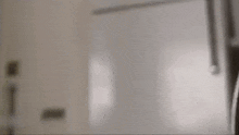 a close up of a toilet seat in a bathroom with a door in the background .