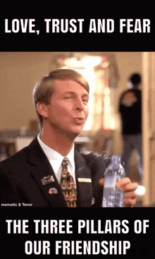 a man in a suit and tie holds a bottle of water and says love trust and fear