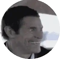 a close up of a man 's face in a circle .