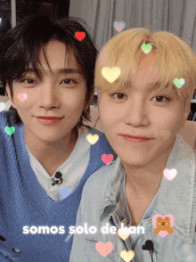 two young men are posing for a picture with hearts and the words somos solo de han