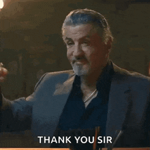 a man in a suit holds a glass of whiskey and says thank you sir