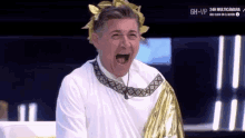 a man dressed as a roman emperor with his mouth open .