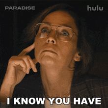 a woman with glasses says " i know you have " in a dark room