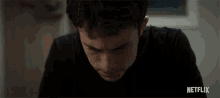 a close up of a man 's face with the word netflix on the bottom right
