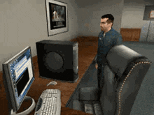 a man is standing in front of a computer with a poster on the wall that says ' open ' on it