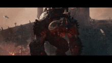 a giant monster with horns is standing in front of a building