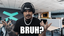 a man wearing headphones and a beanie with the word bruh on it