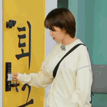 a woman in a white sweater is opening a door with chinese writing on it