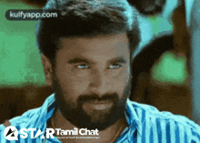 a close up of a man 's face with a star tamil chat logo in the corner