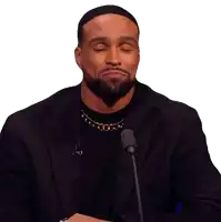 a man with his eyes closed is wearing a black jacket and a gold chain around his neck