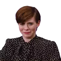 a woman in a black and white polka dot dress is crying