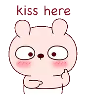 a cartoon bear says kiss here with his hand on his chin .