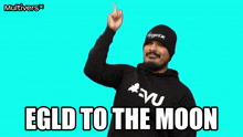 a man wearing a beanie and a hoodie with the words " egld to the moon " on it