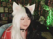 a woman wearing a black and white cat costume with ears