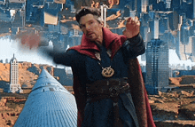 a man in a red cape is standing in front of a city with buildings upside down