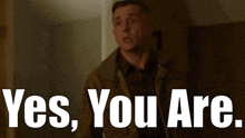 a man in a brown jacket says yes you are in white letters