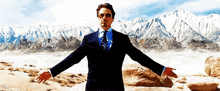 a man in a suit and tie stands in front of mountains