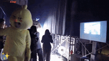 a group of people standing in a dark room with a sign that says log