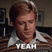 a man in a sweater says yeah in front of him