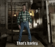 a man in a plaid shirt says that 's barley in a dark room