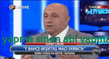 a man in a suit and tie is talking on a television screen