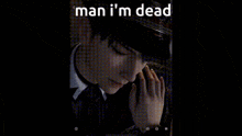 a man in a suit and tie is standing in a dark room .