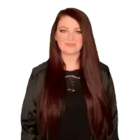 a woman with long red hair is wearing a black jacket and black top