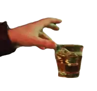 a person 's hand is holding a glass of whiskey