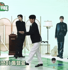 two men are standing next to each other in front of a sign that says vibe on it