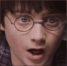 a close up of a person 's face with glasses on