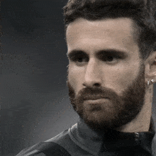 a man with a beard has a tattoo on his left ear that says " i love you "