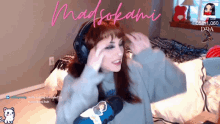 a woman wearing headphones and holding a microphone with the name madsokami written on the bottom