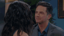 a man and a woman are looking into each other 's eyes