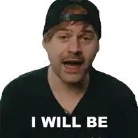 a man wearing a black hat and a black shirt says " i will be "