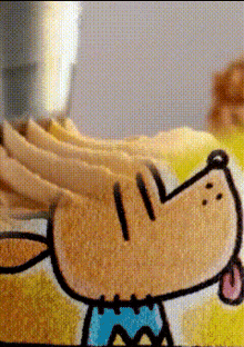 a close up of a cartoon dog on a cake with frosting