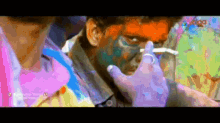 a close up of a man 's face painted with a brush