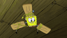 a cartoon drawing of spongebob spinning in a circle on a wooden floor